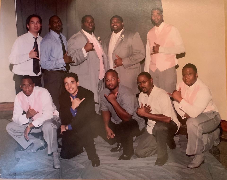 Legends of the Fall brothers in gray formal wear with pink accents, posed together in two rows.