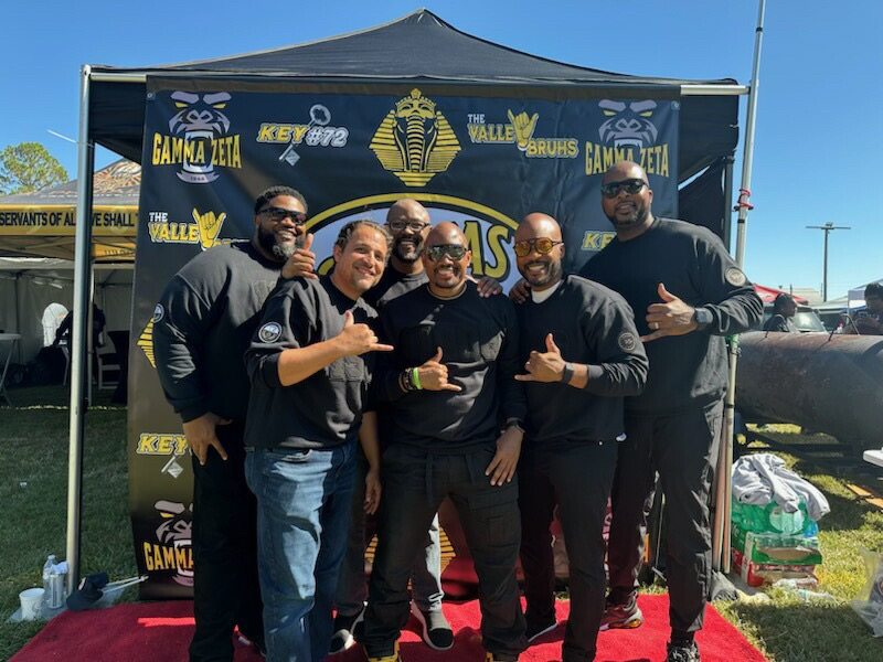 Legends of the Fall brothers reunited at a Gamma Zeta homecoming tailgate, dressed in black in front of the chapter tent banner.